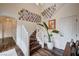 Bright staircase with wood floors, white railings, and a wall decorated with Gathering photos at 167 Thunder Plains Way, Henderson, NV 89012