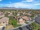 An aerial view of a suburban neighborhood with neatly landscaped homes and mountain views at 1717 Double Arch Ct, Las Vegas, NV 89128