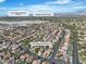 An aerial view of a residential neighborhood featuring mature trees, backyard pools, and the address 1717 Double Arch Ct at 1717 Double Arch Ct, Las Vegas, NV 89128