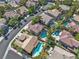 An aerial view showing the neighborhood with lush landscaping and community pools at 1717 Double Arch Ct, Las Vegas, NV 89128
