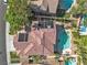 An aerial view of a home with a red-tiled roof, solar panels, and a backyard pool and spa at 1717 Double Arch Ct, Las Vegas, NV 89128
