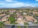 An aerial view of a neighborhood with lush landscaping and mountain views in the background at 1717 Double Arch Ct, Las Vegas, NV 89128