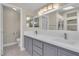 Well-lit bathroom with double sinks, a large mirror, and plenty of counter space at 1717 Double Arch Ct, Las Vegas, NV 89128