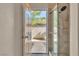 Bathroom with a view to the outside through an open door and a glass shower door at 1717 Double Arch Ct, Las Vegas, NV 89128