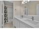 Well-lit bathroom featuring double sinks, a large mirror, and a shower-tub combination at 1717 Double Arch Ct, Las Vegas, NV 89128