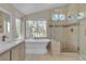 Beautiful bathroom featuring a modern soaking tub, glass enclosed shower, and a vanity at 1717 Double Arch Ct, Las Vegas, NV 89128
