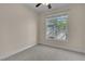 Cozy bedroom with neutral carpet and a window overlooking the backyard at 1717 Double Arch Ct, Las Vegas, NV 89128