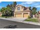 Well-maintained two-story home with three-car garage, mature trees, and lush landscaping in a quiet neighborhood at 1717 Double Arch Ct, Las Vegas, NV 89128