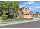 Charming two-story home with a three-car garage, lush landscaping, and well-maintained lawn at 1717 Double Arch Ct, Las Vegas, NV 89128