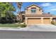 Well-maintained two-story home with three-car garage, mature trees, and lush landscaping in a quiet neighborhood at 1717 Double Arch Ct, Las Vegas, NV 89128