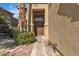 Inviting front entrance with a double door, mature trees, and well maintained landscape at 1717 Double Arch Ct, Las Vegas, NV 89128