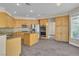 Bright kitchen with wood cabinets, stainless steel appliances, and a center island offers ample counter space at 1717 Double Arch Ct, Las Vegas, NV 89128