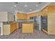 Contemporary kitchen featuring stainless steel appliances, wooden cabinets, and a functional center island at 1717 Double Arch Ct, Las Vegas, NV 89128