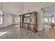 A large entertainment center sits as a room divider with tile floors throughout the space at 1717 Double Arch Ct, Las Vegas, NV 89128