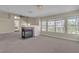 Living room with a fireplace and large windows allowing in natural light at 1717 Double Arch Ct, Las Vegas, NV 89128