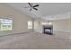 Spacious living room featuring plush carpeting, a cozy fireplace, and plenty of natural light at 1717 Double Arch Ct, Las Vegas, NV 89128