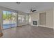 Spacious living room with tile flooring, a ceiling fan and a fireplace at 1717 Double Arch Ct, Las Vegas, NV 89128