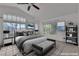 Staged main bedroom with a plush bed, bench, and large windows at 1717 Double Arch Ct, Las Vegas, NV 89128