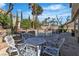 Outdoor patio with white table set next to fenced pool, enhanced by mature vegetation at 1717 Double Arch Ct, Las Vegas, NV 89128