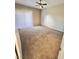 A cozy bedroom with carpet floors, ceiling fan, and vertical blinds at 1881 W Alexander Rd # 1128, North Las Vegas, NV 89032