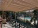 View of the community picnic and grilling area with a pool beyond a fence at 1881 W Alexander Rd # 1128, North Las Vegas, NV 89032