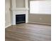 Living room featuring a fireplace, natural light, and wood-look flooring at 1881 W Alexander Rd # 1128, North Las Vegas, NV 89032