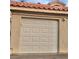 Attached one-car garage with a white door, offering convenient parking and storage at 1881 W Alexander Rd # 1128, North Las Vegas, NV 89032