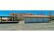 Community garages, covered parking, and building exterior of homes with terracotta tile roofing at 1881 W Alexander Rd # 1128, North Las Vegas, NV 89032