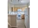 Well-lit kitchen with stainless steel appliances, plenty of counter space, and wood cabinets at 1881 W Alexander Rd # 1128, North Las Vegas, NV 89032