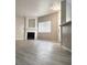 Bright living room featuring a fireplace, modern lighting, and wood-look flooring at 1881 W Alexander Rd # 1128, North Las Vegas, NV 89032