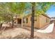 The home's backyard features a covered patio, desert landscaping and a view of the mature landscaping nearby at 2318 Shorewood Hills Ave, Henderson, NV 89052