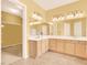 Bright bathroom with a double vanity, updated lighting and a large mirror at 2318 Shorewood Hills Ave, Henderson, NV 89052