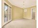 Spacious bedroom with neutral carpet, crown molding, and double doors leading to a patio at 2318 Shorewood Hills Ave, Henderson, NV 89052