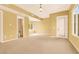 Bright, airy bedroom featuring neutral tones, large windows, and an attached bathroom, offering comfort and convenience at 2318 Shorewood Hills Ave, Henderson, NV 89052