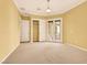 Large bedroom with neutral carpet, closet, and french doors leading to the backyard at 2318 Shorewood Hills Ave, Henderson, NV 89052