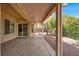 The covered patio has a view of the home's backyard and mature landscaping at 2318 Shorewood Hills Ave, Henderson, NV 89052