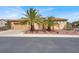 Inviting single-story home featuring a tile roof, desert landscaping and a two-car garage at 2318 Shorewood Hills Ave, Henderson, NV 89052