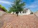 Cozy backyard with privacy walls, low-maintenance landscaping, and covered patio at 2557 Terrytown Ave, Henderson, NV 89052