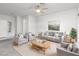 Bright living room with neutral tones, ceiling fan, and comfortable seating arrangement at 2557 Terrytown Ave, Henderson, NV 89052