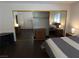 Bedroom with wood floors that includes dresser, corner shelf, bed, and mirrored closet doors at 2704 Otter Creek Ct # 101, Las Vegas, NV 89117