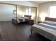 Bedroom showcasing a mirrored closet, wood-framed bed, matching nightstands, and ample closet space at 2704 Otter Creek Ct # 101, Las Vegas, NV 89117