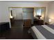 Bedroom with wood floors featuring a modern bed, ample lighting, and closet at 2704 Otter Creek Ct # 101, Las Vegas, NV 89117