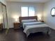 Comfortable bedroom featuring a modern bed, ample lighting, and wood floors at 2704 Otter Creek Ct # 101, Las Vegas, NV 89117