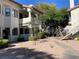 Exterior view of a condo building with mature trees, shrubs and walkways leading to the units at 2704 Otter Creek Ct # 101, Las Vegas, NV 89117