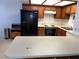 Well-lit kitchen features wood cabinets, black appliances, and a spacious countertop area at 2704 Otter Creek Ct # 101, Las Vegas, NV 89117