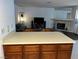 Kitchen island overlooking a living room with a stone fireplace at 2704 Otter Creek Ct # 101, Las Vegas, NV 89117