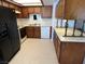 Functional kitchen with dark wood cabinetry, modern appliances, and ample counter space at 2704 Otter Creek Ct # 101, Las Vegas, NV 89117