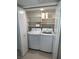 A convenient laundry closet complete with a washer and dryer and shelving at 2704 Otter Creek Ct # 101, Las Vegas, NV 89117