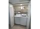 Laundry room offers modern washer, dryer, and shelving for organized storage at 2704 Otter Creek Ct # 101, Las Vegas, NV 89117