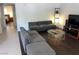Spacious living room with tile and hardwood floors and a gray sectional couch at 2704 Otter Creek Ct # 101, Las Vegas, NV 89117